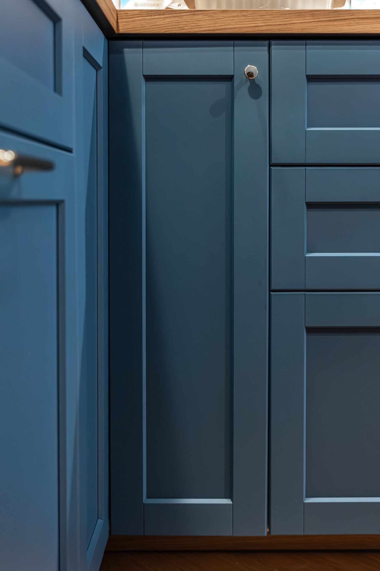 Close up of pull out drawers showing a practical storage system and smooth front lines. A scene about space organizing, functionality and minimalist interior design.