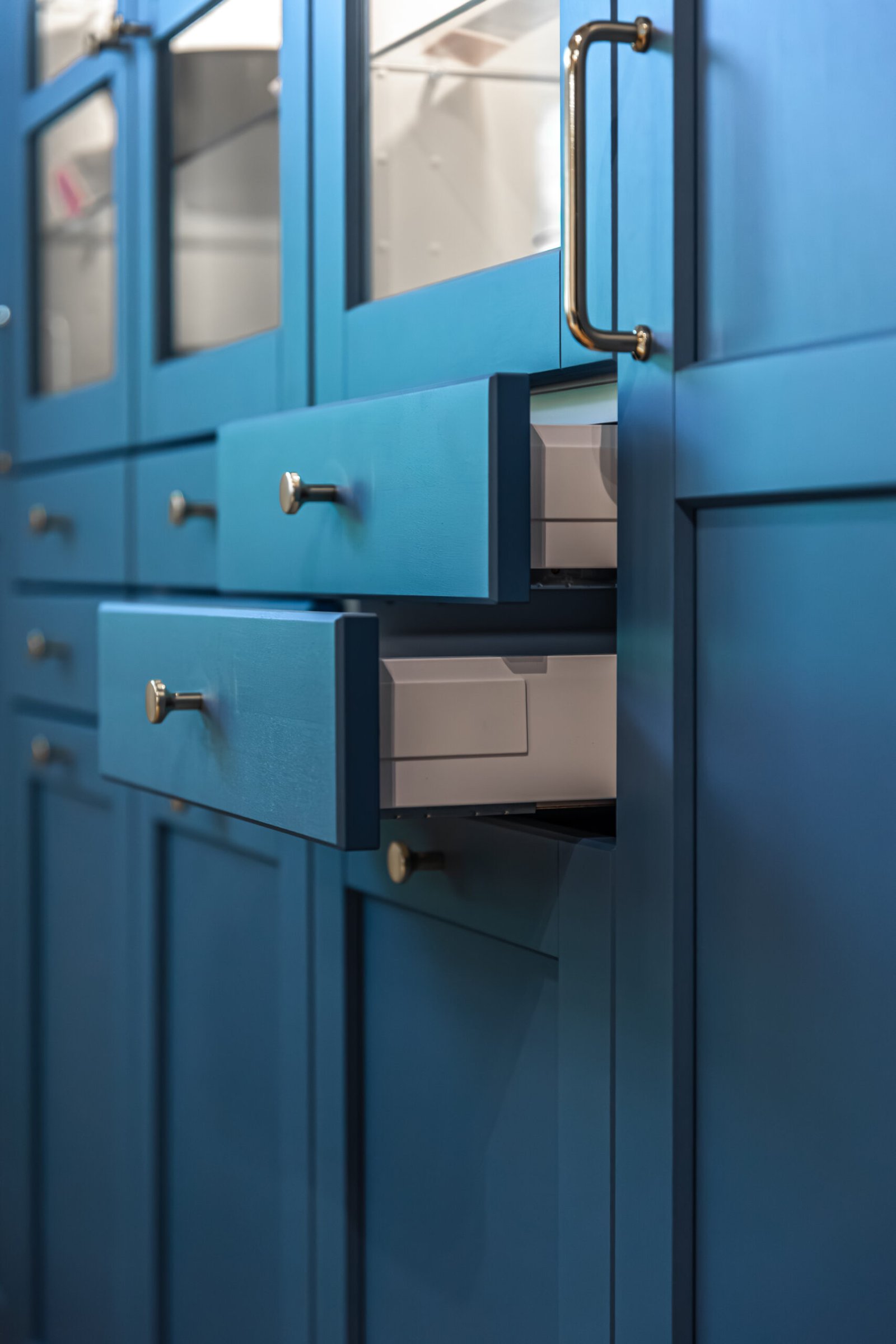 The image highlights deep blue color, precise gaps and soft handle shadows. A visual for neat organizing, renovation mood and modern minimal interior style.